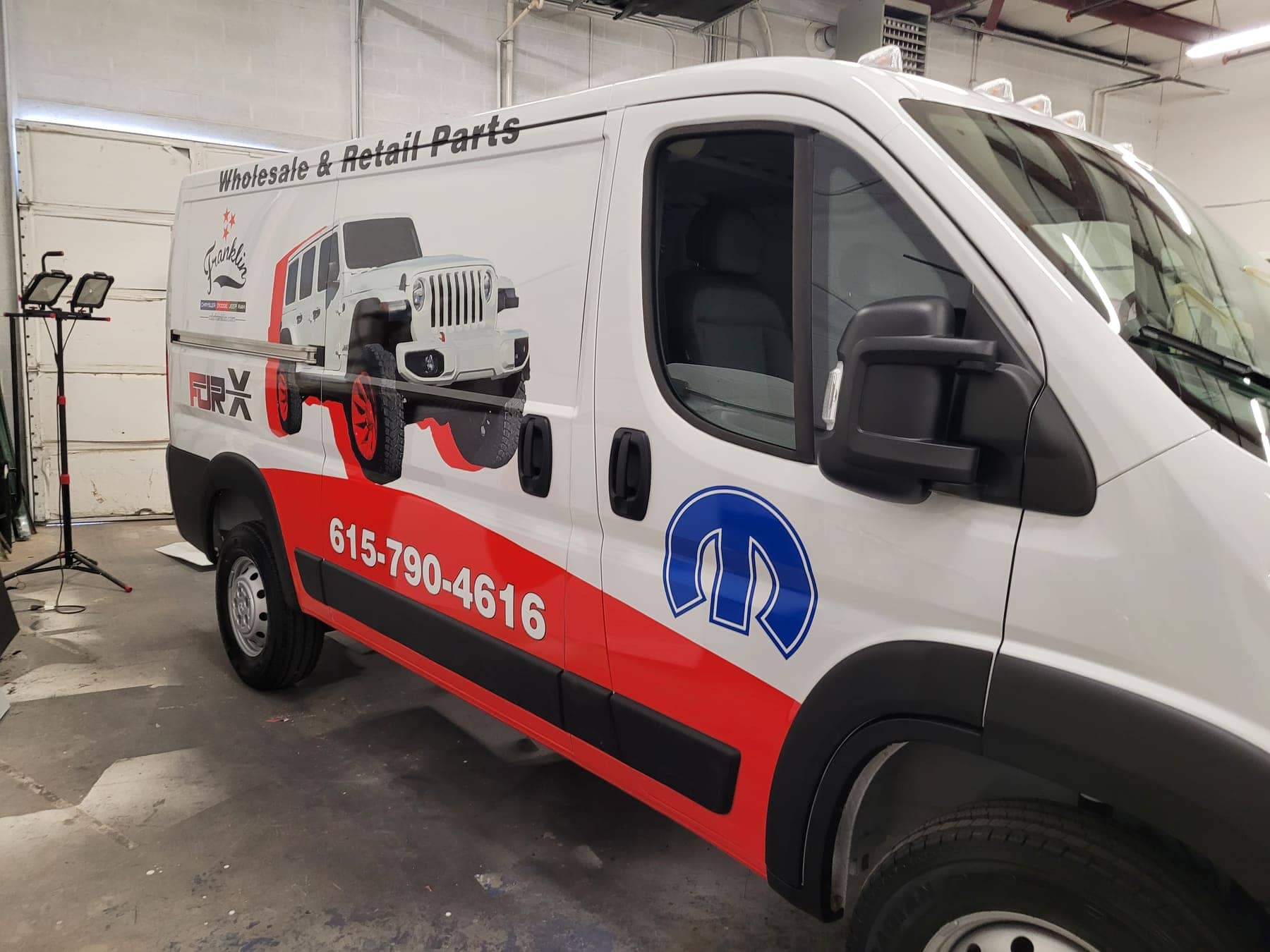 Ram ProMaster van with red and black Mopar parts-department graphics for Franklin CDJR