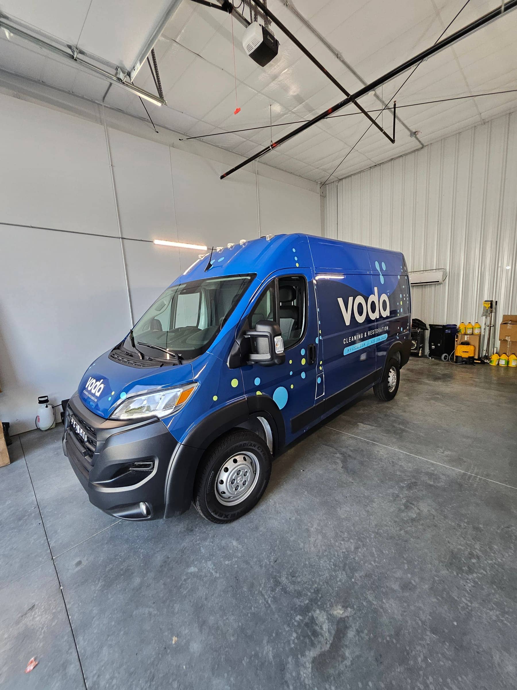 Blue Ram ProMaster van with dotted-pattern partial wrap for Voda Cleaning and Restoration