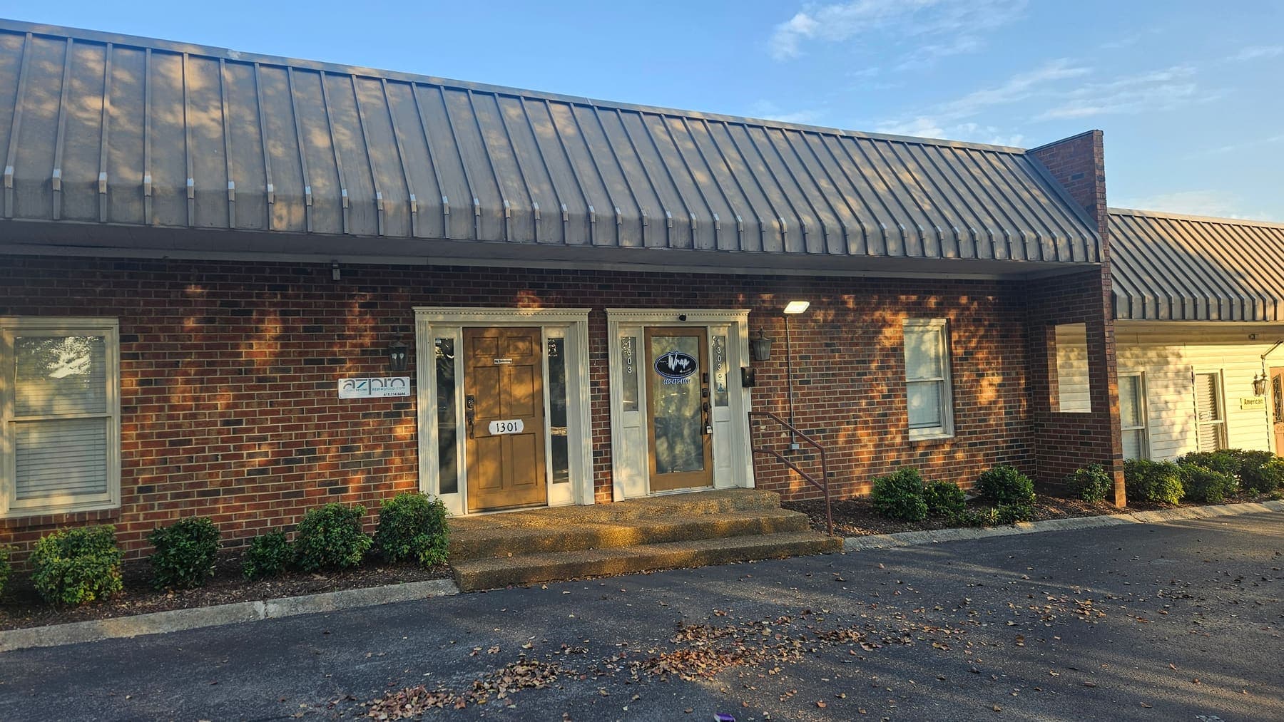 Brick office building with fresh azpro storefront signage above the entrance