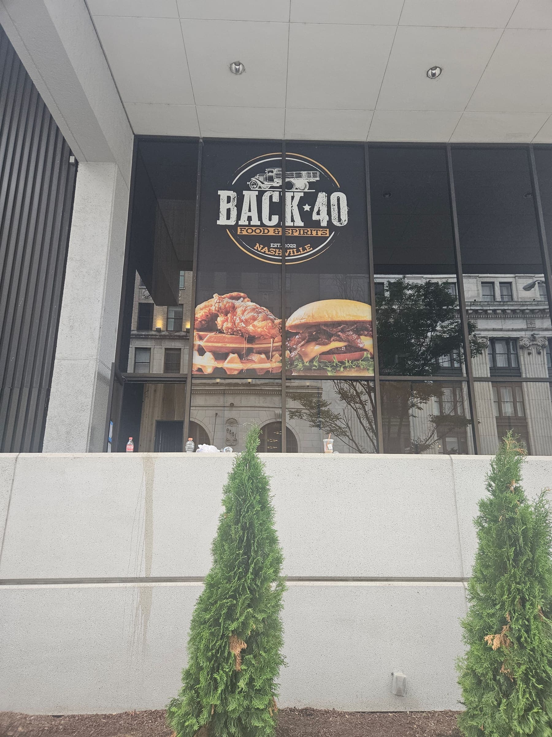 Restaurant windows with burger photography and Back 40 Food and Spirits logo graphics