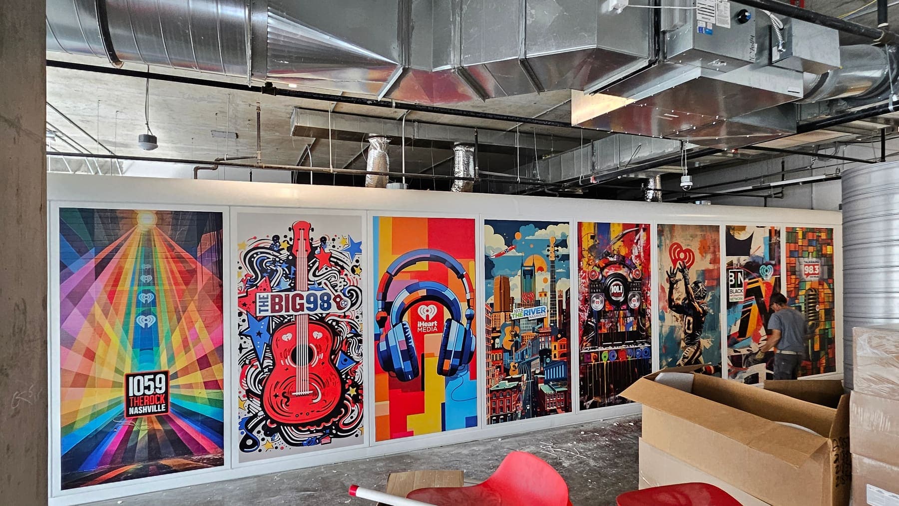 Hallway of printed art panels with music themes at the iHeart radio offices