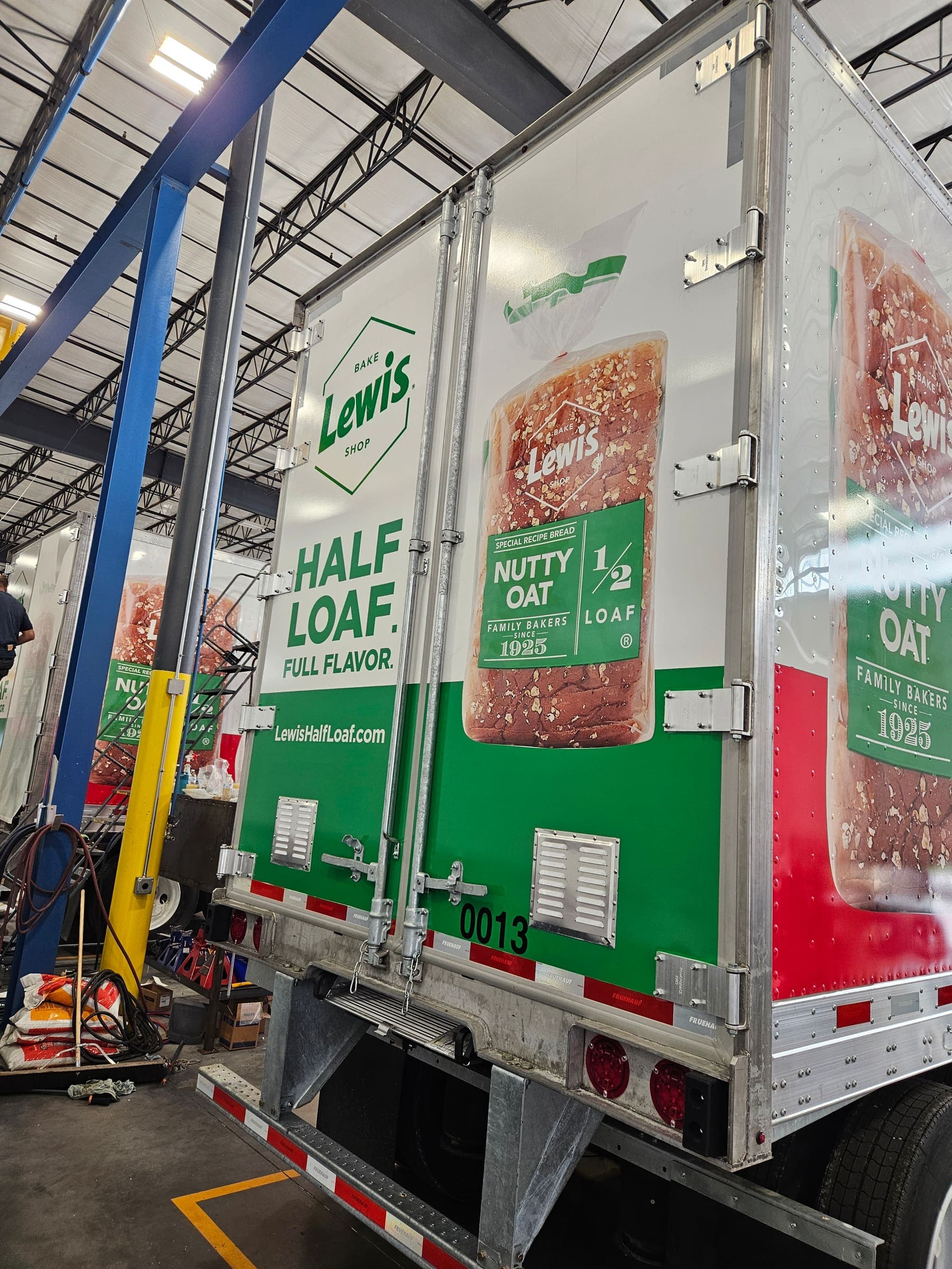 Rear doors of the trailer wrapped in bread packaging graphics around the door hardware