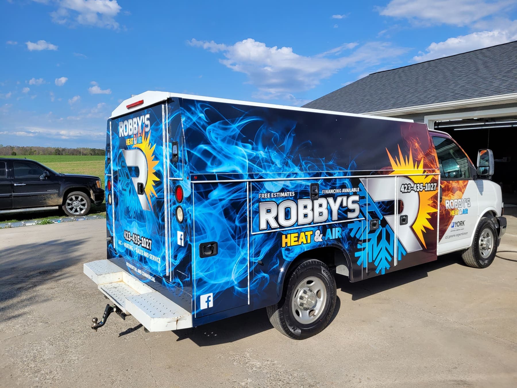 Rear of the Robby's Heat and Air van showing flame graphics wrapping the doors