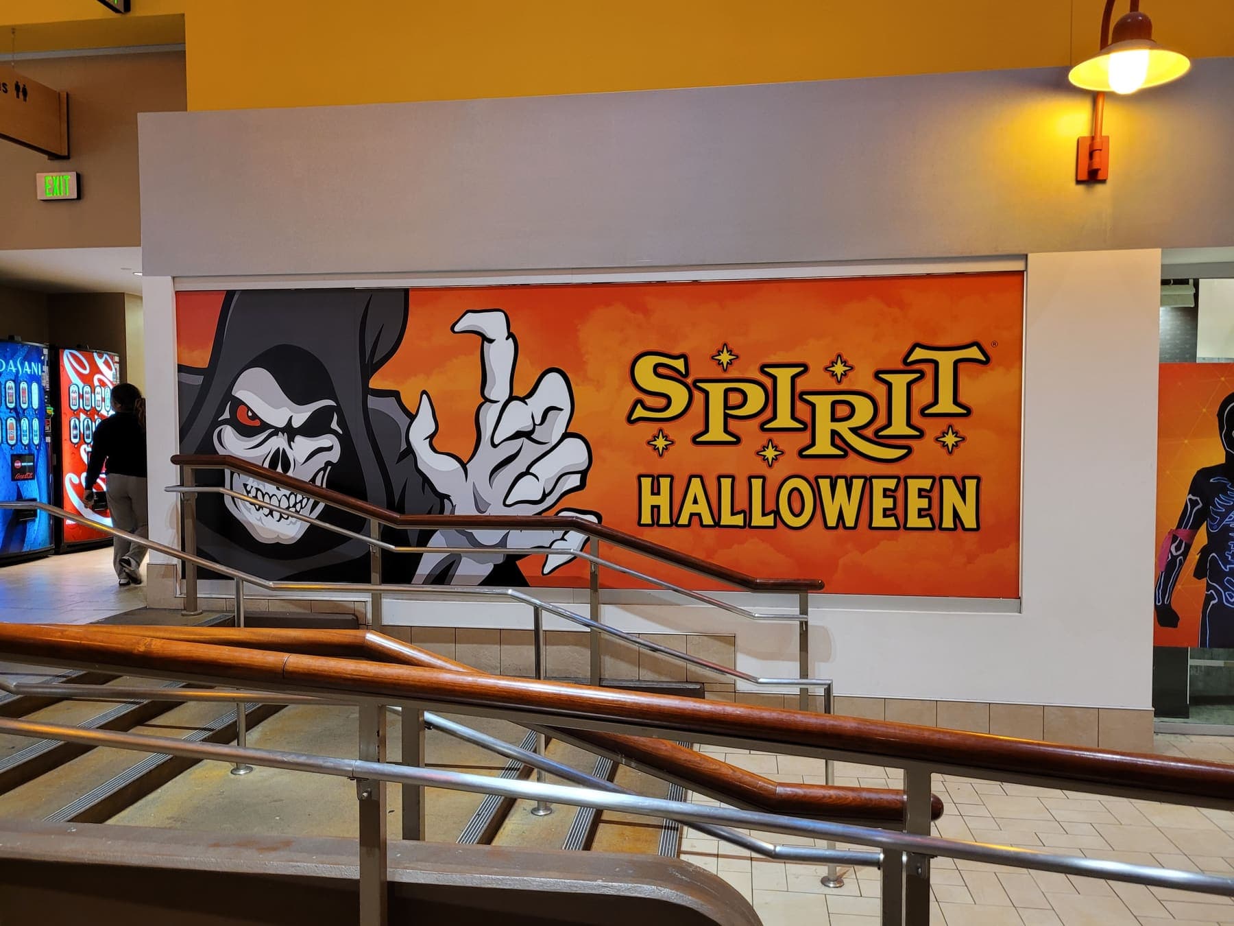 Reaper-artwork storefront banner going up at a Spirit Halloween location