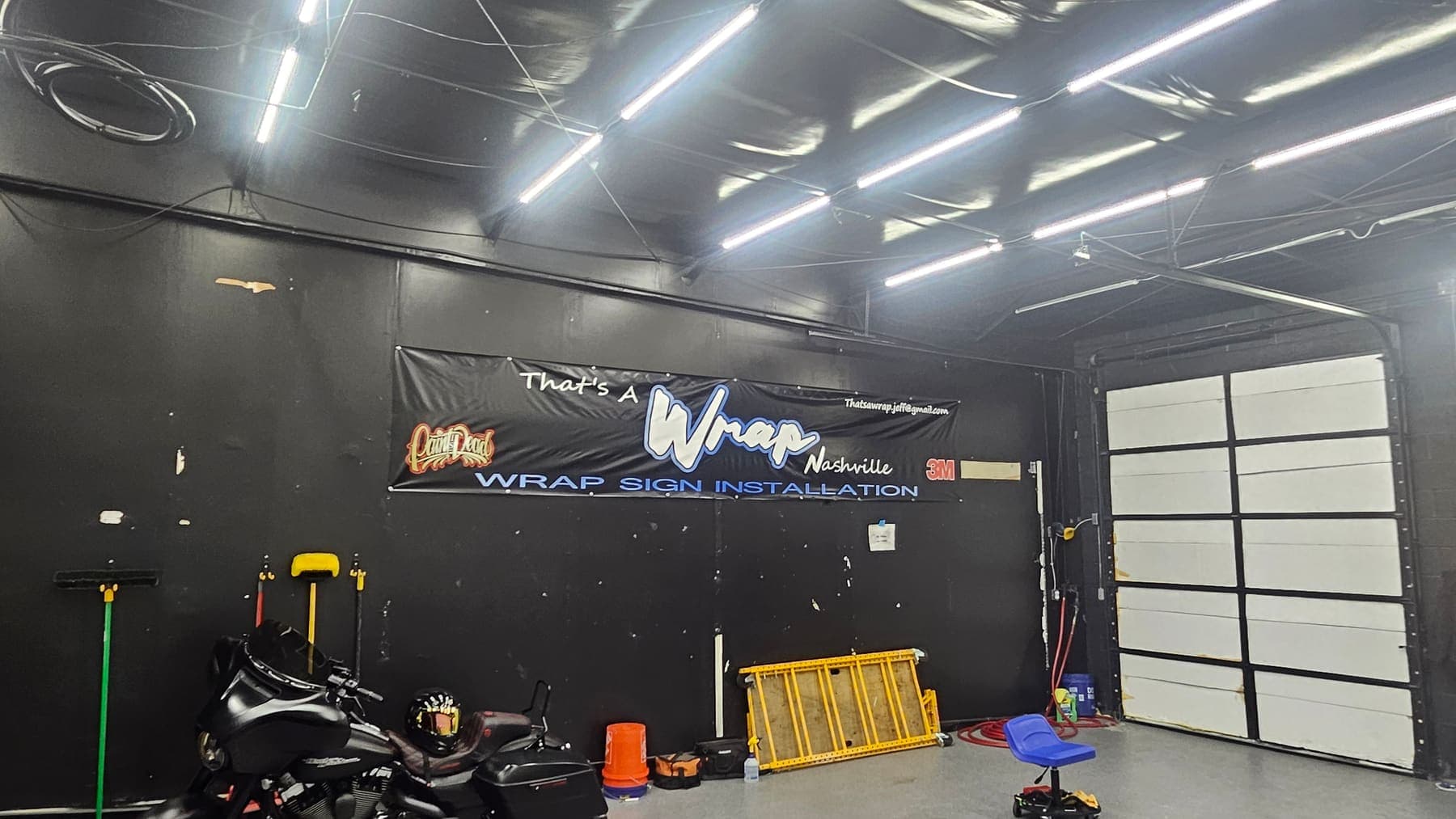 The That's a Wrap Nashville install bay with the shop banner on the back wall