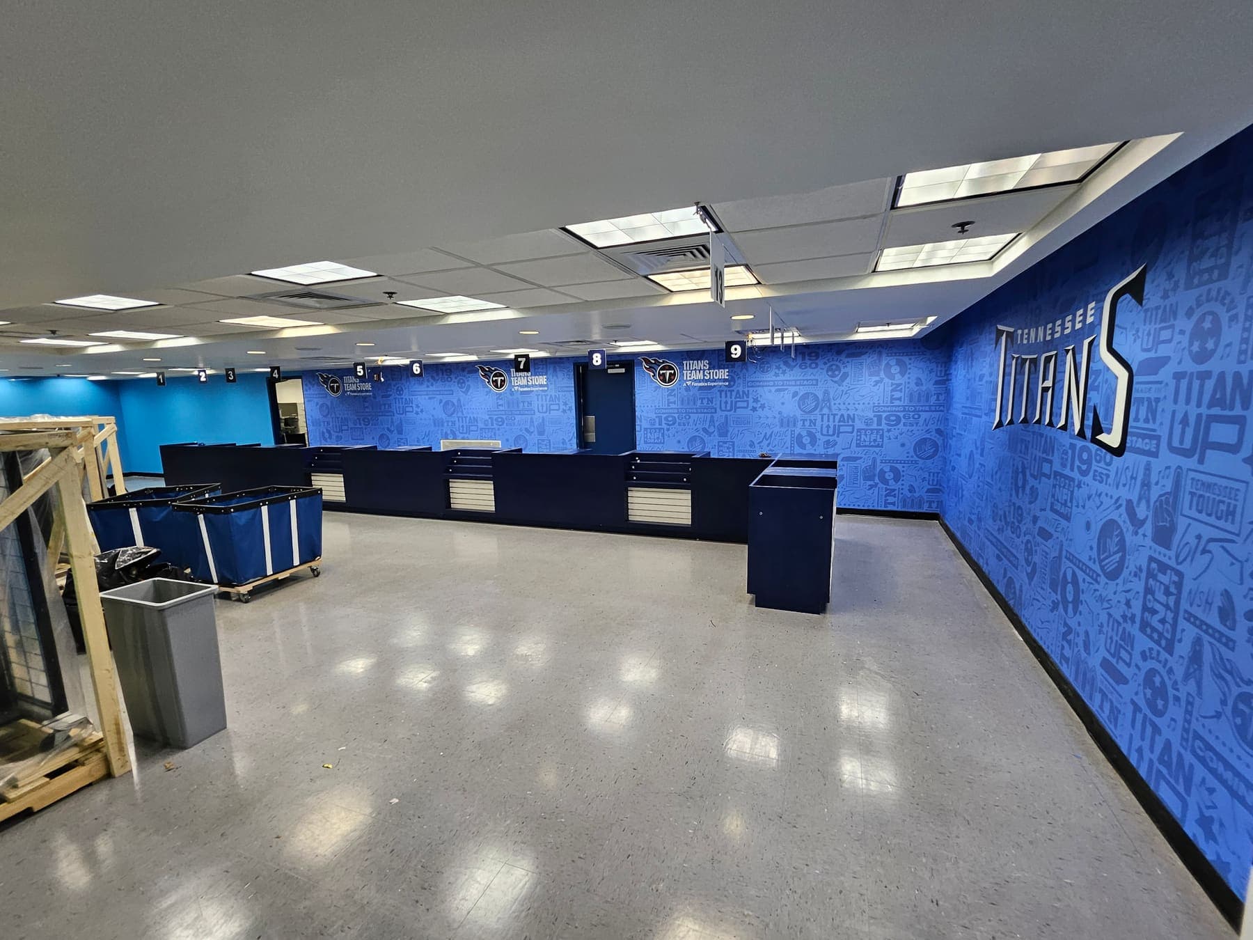 Checkout counters and back wall of the Titans store covered in coordinated graphics