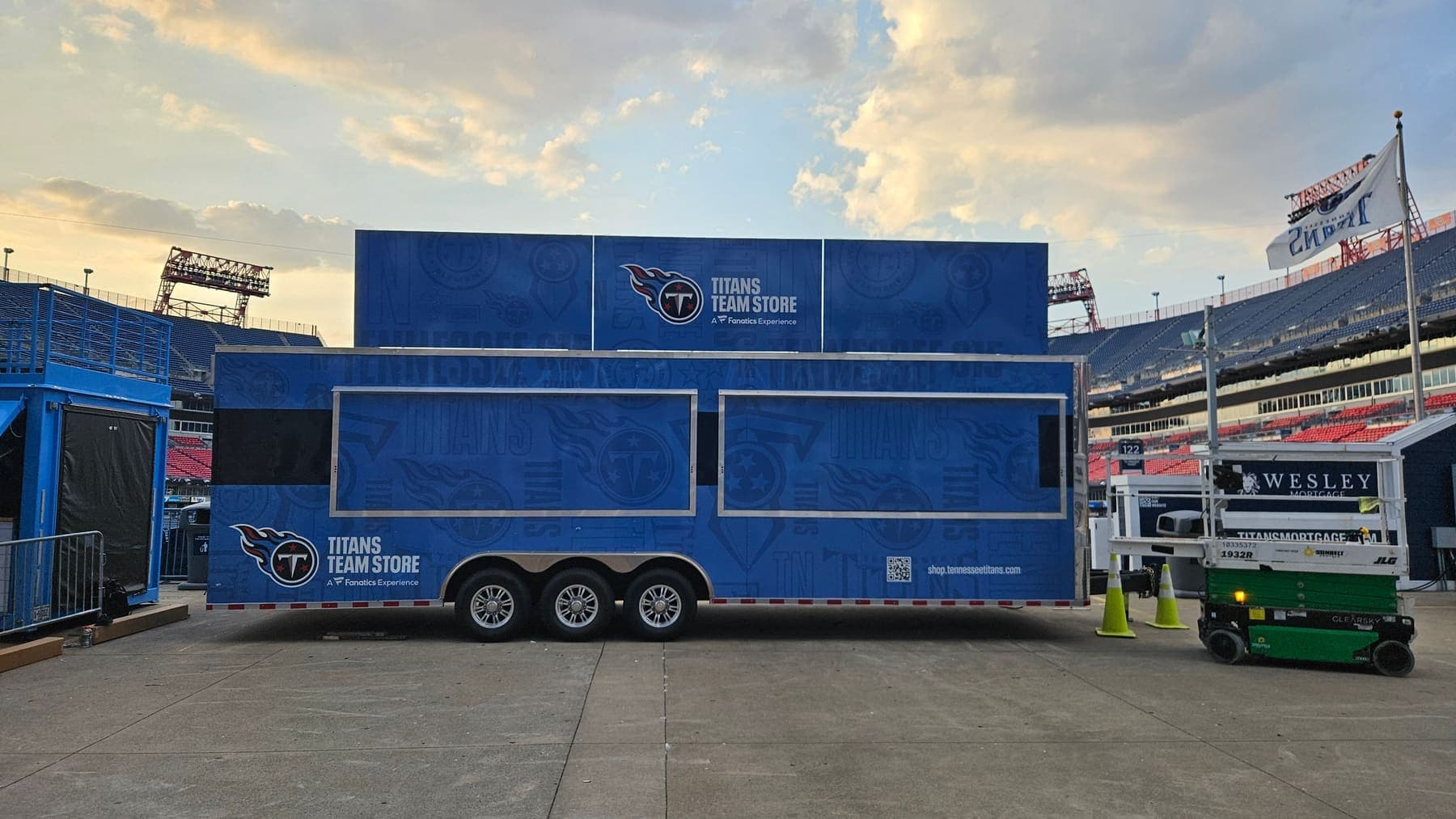 Titans Team Store trailer deployed open on the stadium plaza at sunrise