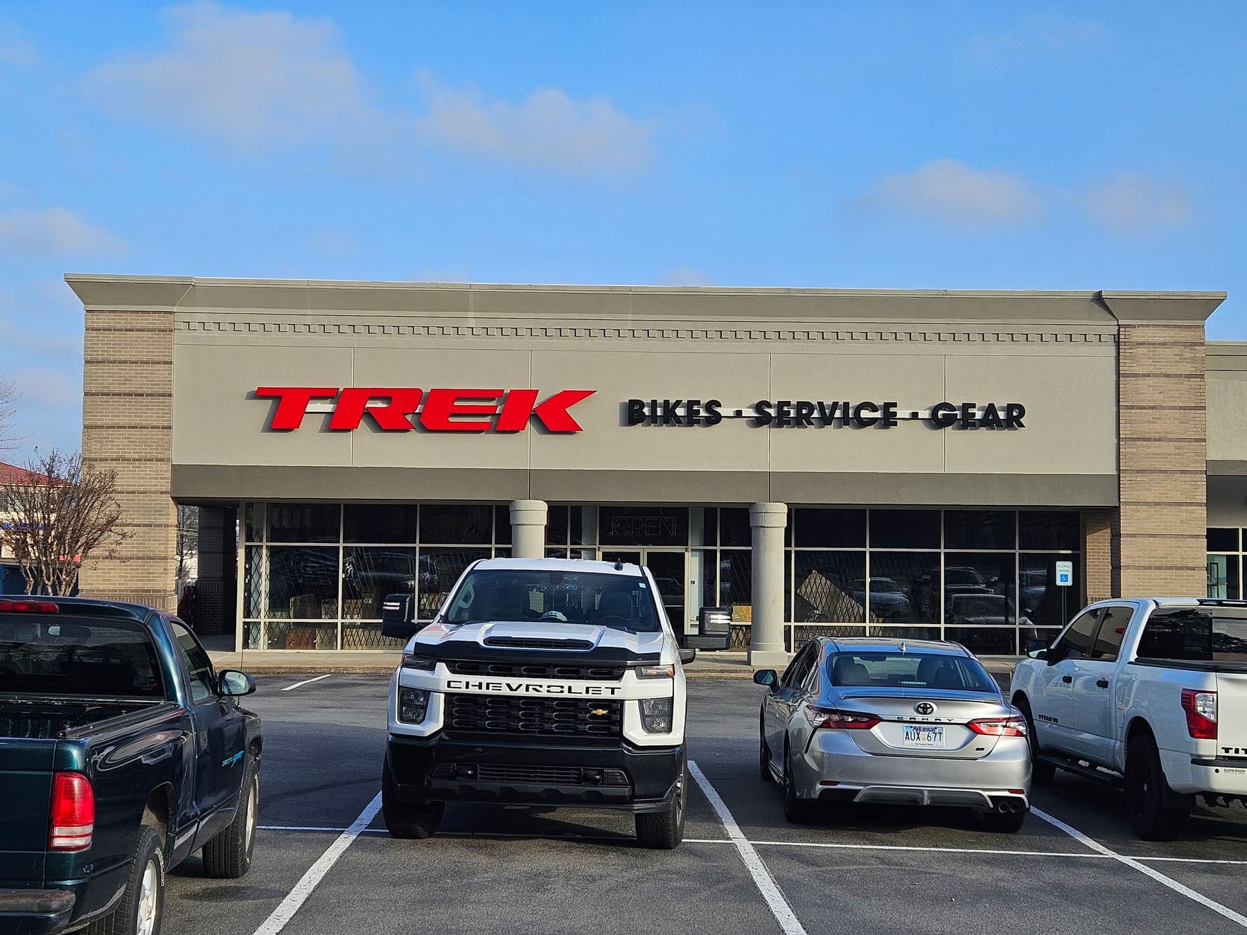 Red Trek channel letters mounted on a storefront fascia