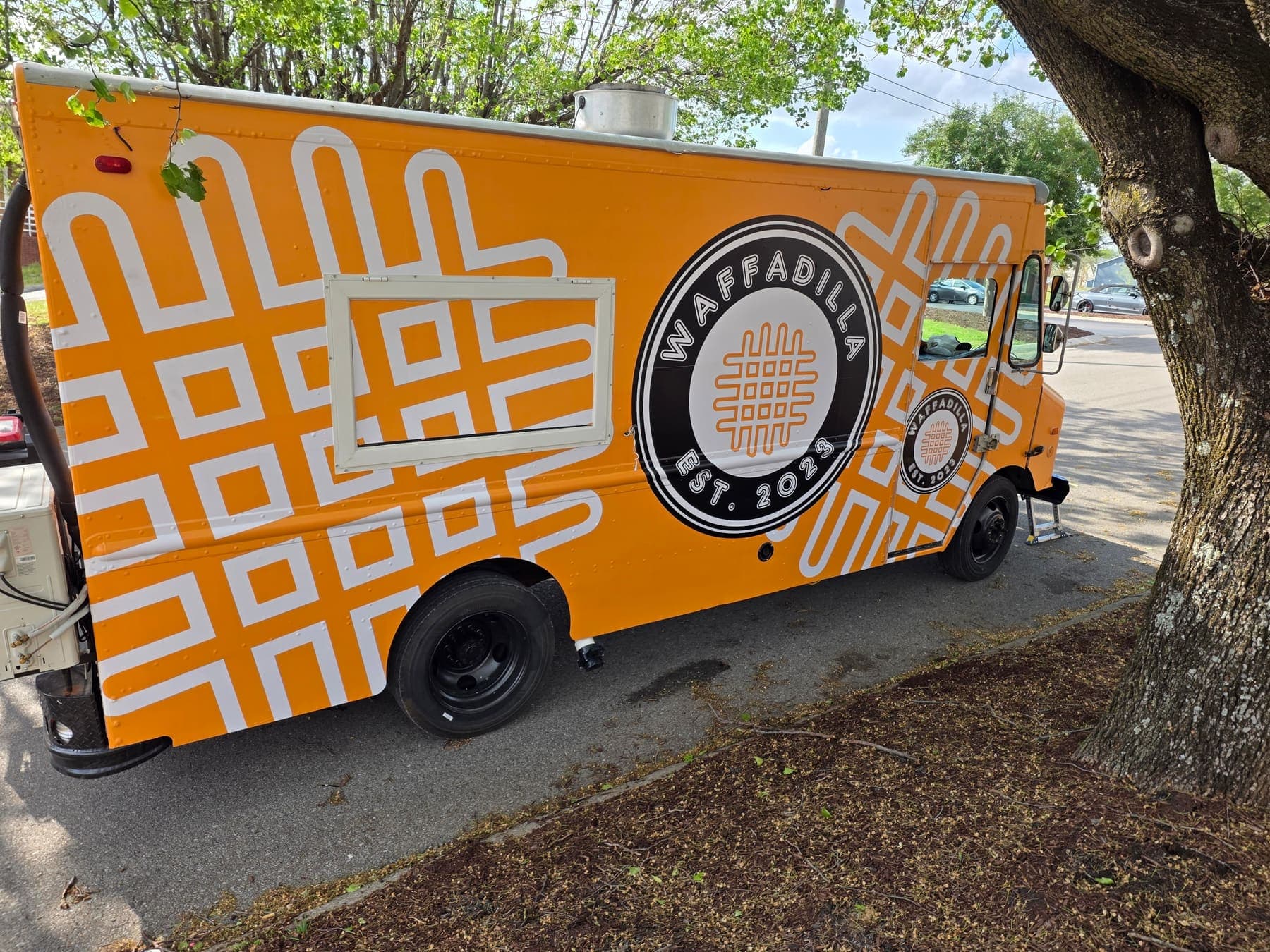 Orange Waffadilla food truck wrapped with a geometric waffle pattern